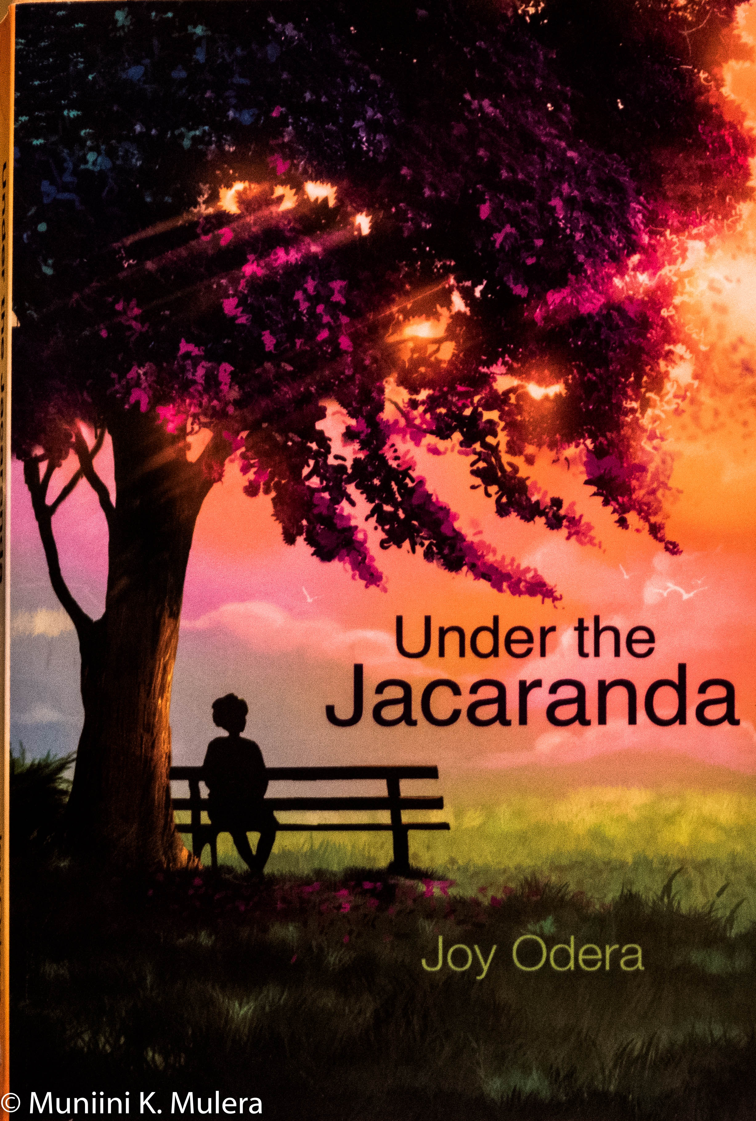 Under the Jacaranda  - by Joy Odera